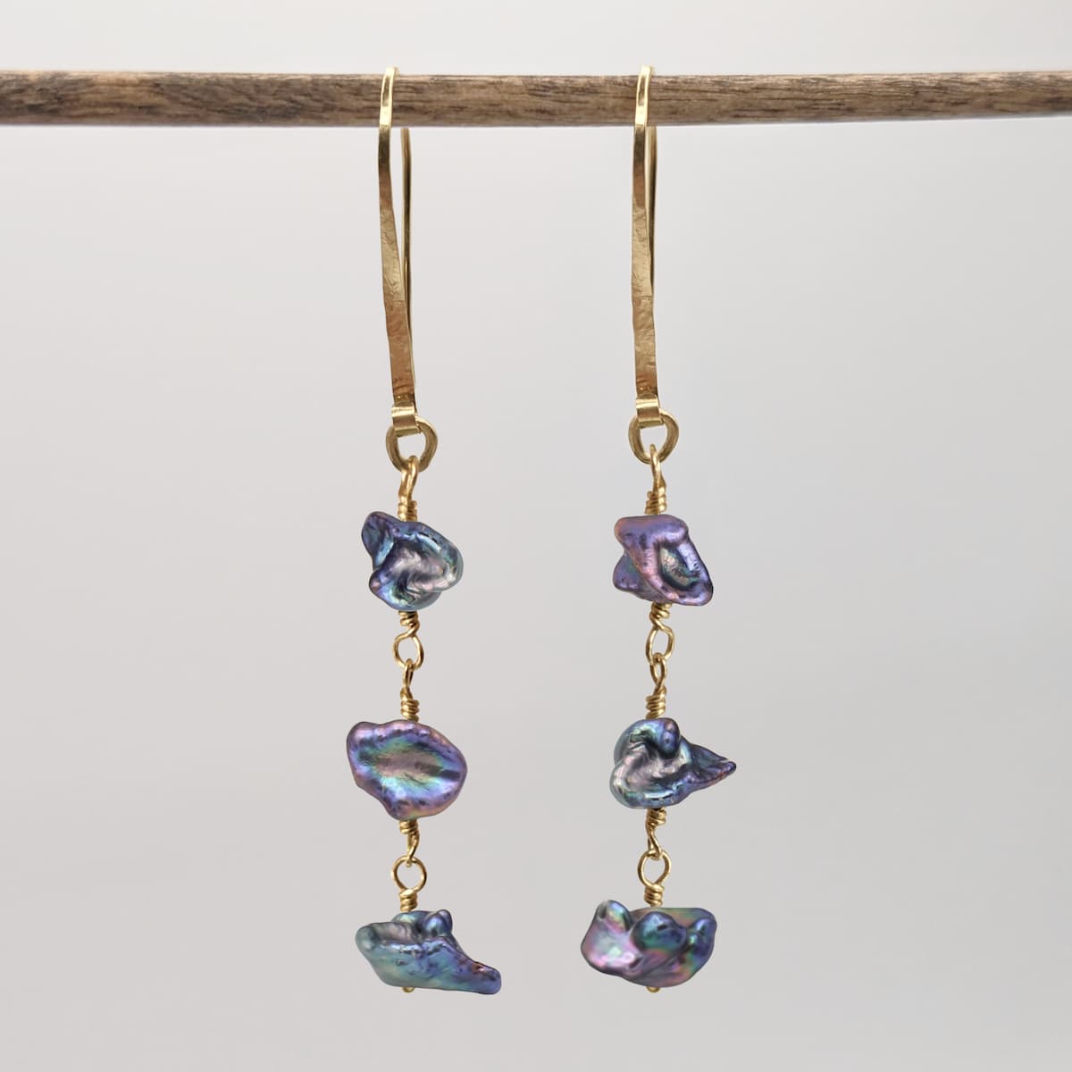 Handmade gold earrings with peacock keshi pearls